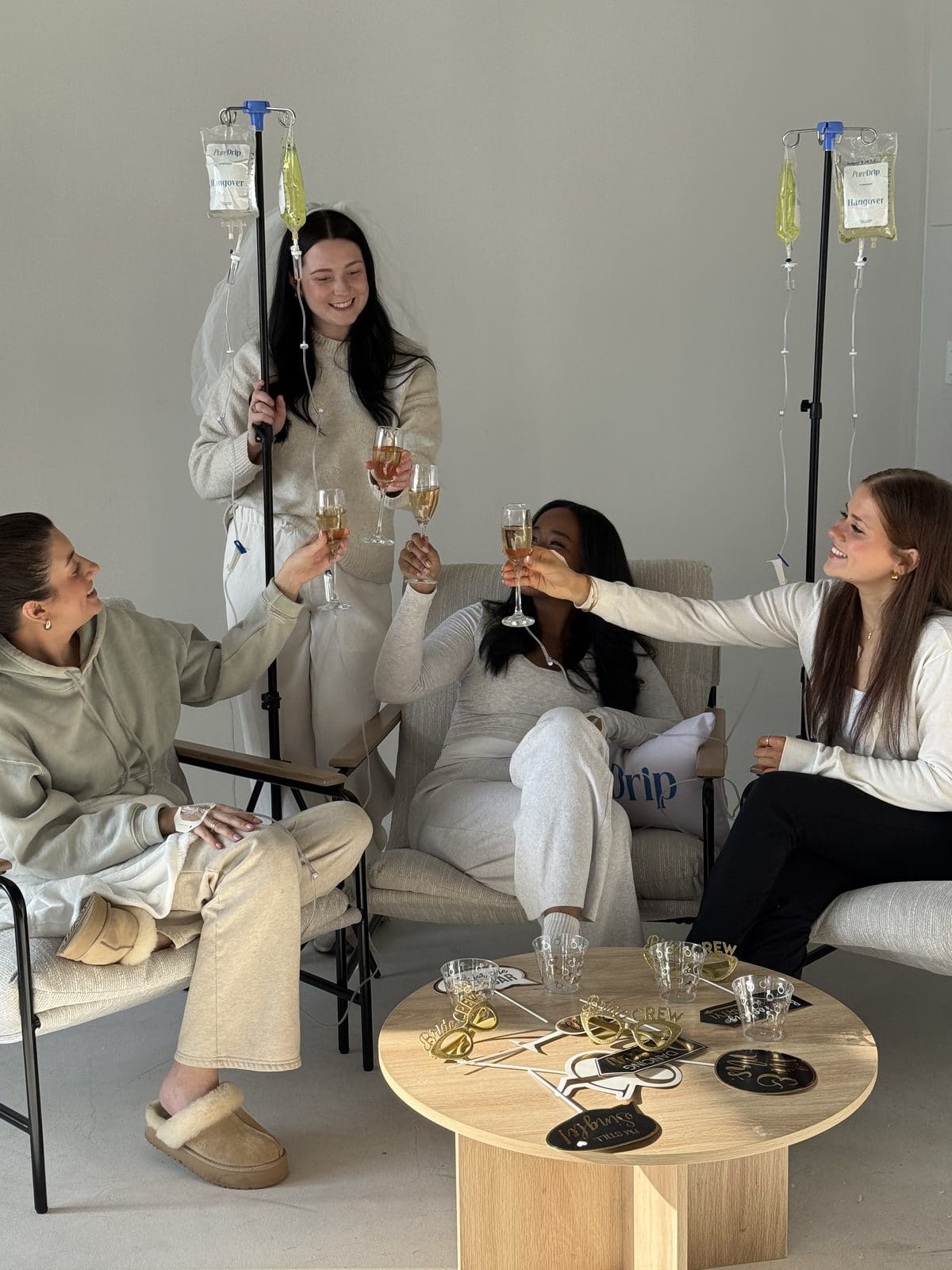 A group of clients toasting together during a Pure Drip private event IV session